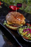 Delicious fresh juicy burger with beef cutlet, cheese, with salads photo