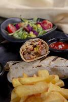 Pita bread lavash roll chicken doner kebab and fresh vegetables photo