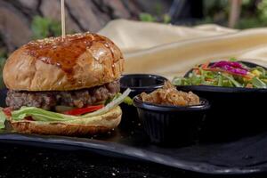 Delicious fresh juicy burger with beef cutlet, cheese, with salads photo