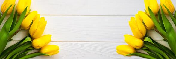 Banner. Festive composition with bouquets of yellow tulips on a white wooden background. Flatlay. Top view. Copy space. photo