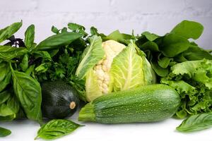 Variety of green vegetables on white background. Healthy food. Close-up. Selective focus. photo