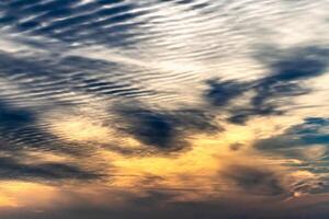 Beautiful striated cloud formation in sky looking like fluffy waves, weather forecast photo