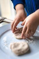 Child having fun modeling dough, authentic activity for fine motor skills development photo