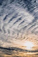 Beautiful striated cloud formation in sky looking like fluffy waves, weather forecast photo