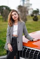 Woman Leaning on Hood of Car photo