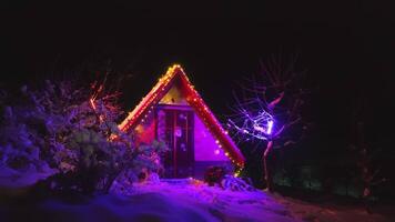 Santa Claus's winter booth is illuminated with different colors video