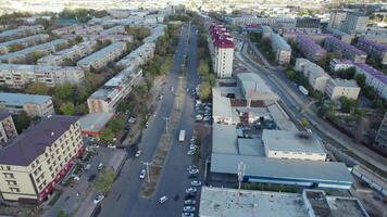 A drone flies over a truck driving through the streets of the city. Cloudy day video