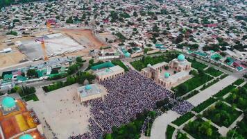 A drone flies over the mosque complex during prayers. Believers pray in the courtyard. A cloudy summer day. video