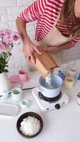 woman making candles from soy wax video