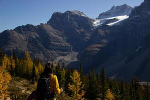 Woman hiker walking through the Rocky Mountains of Canada. photo