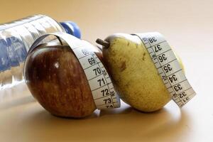 Apple and pear fruits representing forms of obesity photo