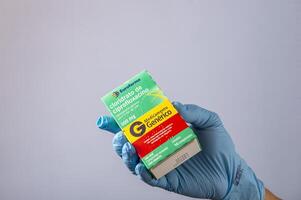 Rio, Brazil - January 27, 2023, hand with protective rubber glove holding medicine box, cipofloxacin hydrochloride photo