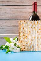 Celebrating spring holiday Passover. Bottle of wine and traditional Jewish matzo bread photo