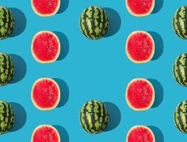 Trendy fruit pattern composition made with ripe and fresh watermelon on blue background. Minimal summer food concept. Creative summer pattern background with copy space idea. Watermelon aesthetic. photo