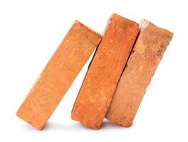 Side view of cracked old red or orange bricks in stack isolated on white background with clipping path photo