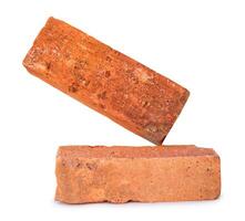 Side view of cracked old red or orange bricks in stack isolated on white background with clipping path photo