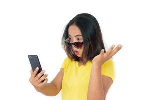 Asian woman in t-shirt with smartphone over white background. photo