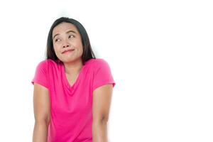 Photo of happy young woman standing isolated over white wall background