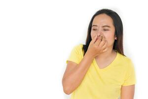 woman holding her nose because of bad smell isolated on a white background photo