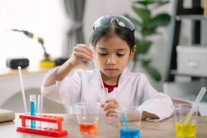 asiático niña haciendo químico experimentos a el laboratorio foto