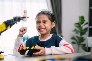 Asian girls were learning robot programming and getting lessons control on robot arms. Laboratory. Mathematics, engineering, science, technology, computer code, coding. STEM education. photo