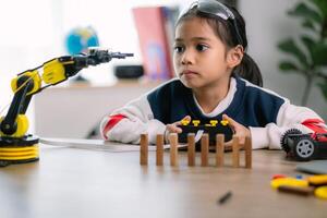 asiático muchachas fueron aprendizaje robot programación y consiguiendo lecciones controlar en robot brazos. laboratorio. matemáticas, ingeniería, ciencia, tecnología, computadora código, codificación. vástago educación. foto