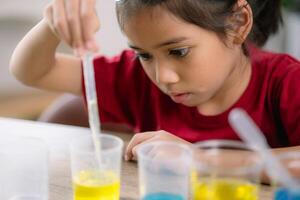 Asian girl doing chemical experiments at the lab photo