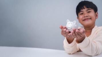 A boy holding piggy bank. Learning financial responsibility and projecting savings. savings concept. investment concept. photo