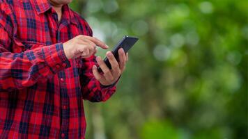 Smart farming with IoT, Growing plant seedlings infographic, Smart farming and precision agriculture 4.0, Farmer hand holding smartphone on green background. photo