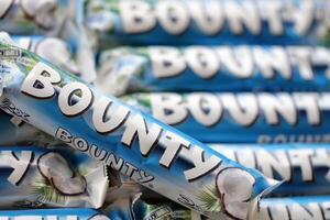 KYIV, UKRAINE - OCTOBER 31, 2023 Bounty chocolate bars with cocoa flavor filling. Bounty chocolate bar is a brand of American Mars Inc photo