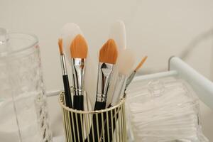 Close-up of brushes in a glass in the cosmetologist's office. photo