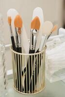 Close-up of brushes in a glass in the cosmetologist's office. photo