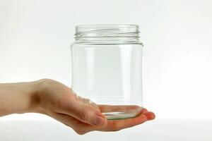 AI generated Transparent Glass Jar in Hand Isolated on White Background photo