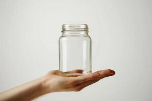 AI generated Empty Glass Jar on Hand Isolated on White Background photo