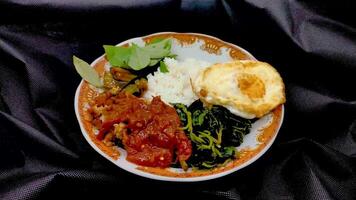 a plate of pecel lele or tempe penyet rotating on a plain background video