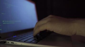 Close-up hacker hands using laptop. video