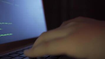 Hacker male hands types on laptop keyboard, and works. video