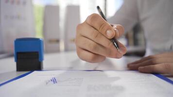 Businessman reading business documents and signing. video