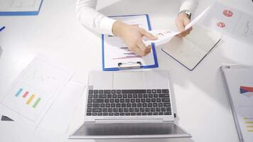 Businessman working at his desk rejoices. video