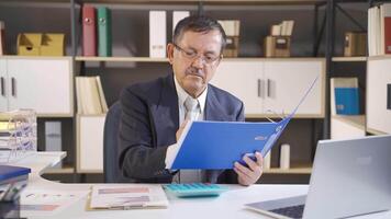 Businessman looking at files. video
