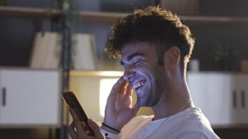 Young man looking at the phone at night. video