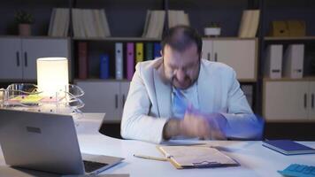 Businessman working at night is angry. video