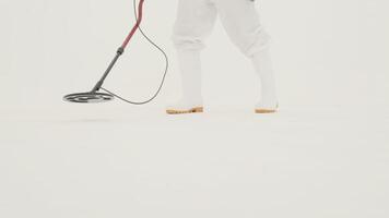 Man in white chemical protection suit holds metal detector video