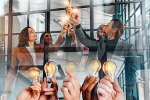 Teamwork and brainstorming concept with businessmen that share an idea with a lamp photo