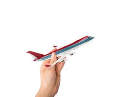 mano sostiene un juguete avión de línea Listo a mosca foto