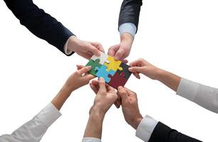 businessmen working together to build a puzzle as teamwork, partnership and integration concept photo