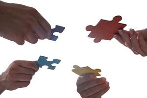 businessmen working together to build a puzzle as teamwork, partnership and integration concept photo