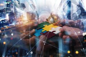 Teamwork of partners connect puzzle pieces as integration and startup photo
