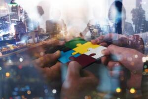 Teamwork of partners connect puzzle pieces as integration and startup photo