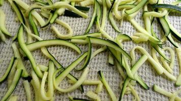 Zucchini cut into strips and placed on a cotton cloth to dry photo